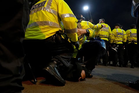 Police officers remove a pro-Palestinian protester outside Villa Park ahead of the Europa League soccer match between Aston Villa and Maccabi Tel Aviv in Birmingham, England.