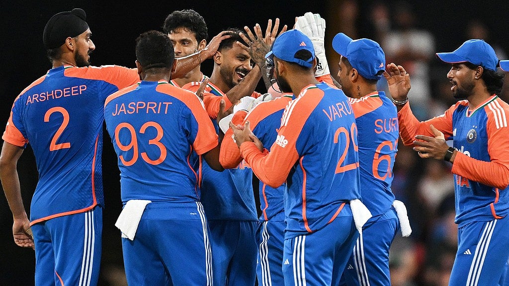 Dave Hunt/AAPImage via AP : Axar Patel, centre, is congratulated by teammates after dismissing Matt Short during the fourth T20I between India and Australia in Carrara.