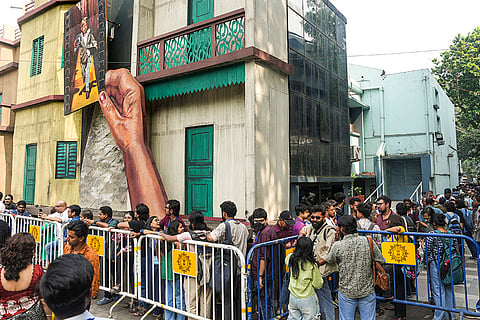 Film enthusiasts wait in a queue to attend the ongoing 31st Kolkata International Film Festival (KIFF), in Kolkata. 