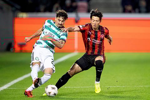 Celtic's Sebastian Tounekti, left, in action with Midtjylland's Han-Beom Lee during the Europa League soccer match between FC Midtjylland and Celtic FC in Herning, Denmark. 