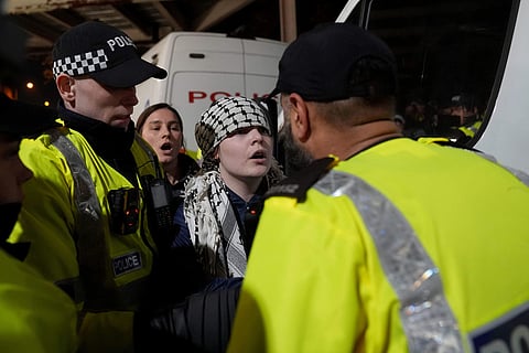 Police officers remove a pro-Palestinian protester outside Villa Park ahead of the Europa League soccer match between Aston Villa and Maccabi Tel Aviv in Birmingham, England.