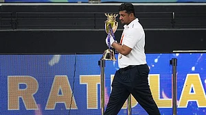 AP : An official removes the winners' trophy from the presentation area after India won the Asia Cup cricket final against Pakistan at Dubai International Cricket Stadium.