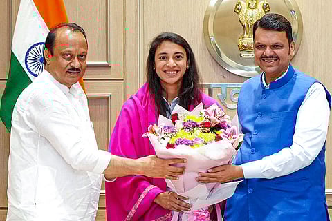 In this image, Maharashtra Chief Minister Devendra Fadnavis with Deputy Chief Minister Ajit Pawar felicitates Smriti Mandhana, member of the Women's ODI World Cup 2025-winning Indian cricket team.