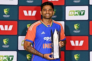 | Photo: PTI/Izhar Khan : India's captain Suryakumar Yadav poses with the series trophy at the end of the five match T20I cricket series between India and Australia, in Brisbane, Australia. The fifth match got abandoned due to rain and India won the series 2-1.