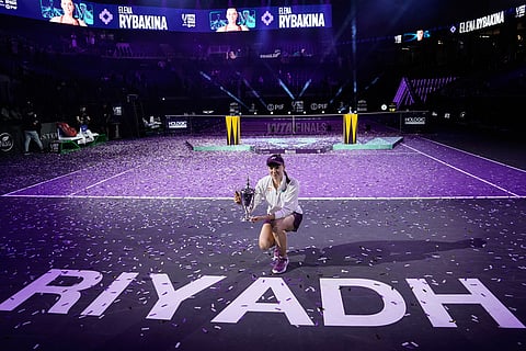 Elena Rybakina of Kazakhstan poses with the trophy after defeating Aryna Sabalenka of Belarus in the women's final singles match of the WTA finals in Riyadh, Saudi Arabia.