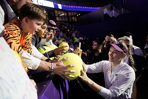 Elena Rybakina of Kazakhstan signs autographs for fans after her win in the women's singles match against Aryna Sabalenka of Belarus in the women's final singles match of the WTA finals in Riyadh, Saudi Arabia.