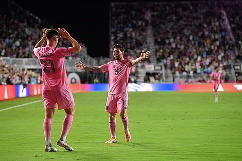 Inter Miami forward Tadeo Allende (21) celebrates with Lionel Messi (10) after a goal during the second half of Game 3 in the first round of MLS soccer's Western Conference playoffs against Nashville SC in Fort Lauderdale, Florida.