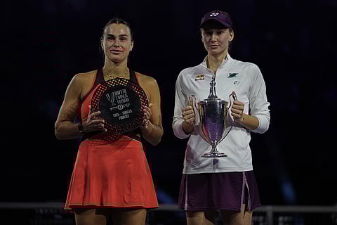 Elena Rybakina of Kazakhstan, right, holds her trophy poses with runner up Aryna Sabalenka of Belarus during the awards ceremony for the women's singles final match of the WTA finals in Riyadh, Saudi Arabia.