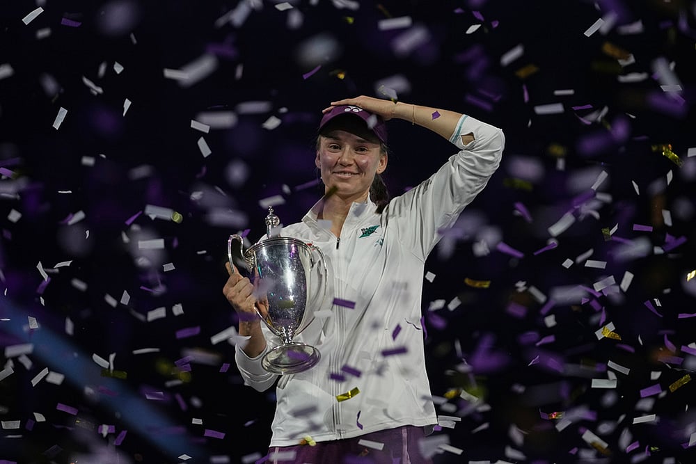 Elena Rybakina of Kazakhstan celebrates with her trophy after defeating Aryna Sabalenka of Belarus in the women's final singles match of the WTA finals in Riyadh, Saudi Arabia. - | Photo: AP/Fatima Shbair