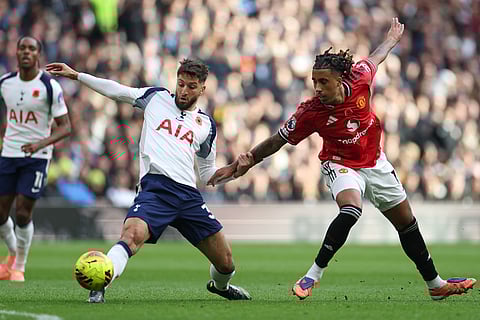Manchester United's Joshua Zirkzee, right, challenges for the ball with Tottenham's Rodrigo Bentancur during the English Premier League soccer match between Tottenham Hotspur and Manchester United in London, England.