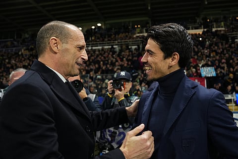 AC Milan's head coach Massimiliano Allegri, left, and Parma's head coach Carlos Cuesta greet each other prior to the Serie A soccer match between Parma and Milan in Parma, Italy.