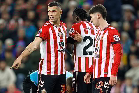 Sunderland's Granit Xhaka (left) instructs his team-mates ahead of a free-kick during the English Premier League soccer match between Arsenal and Sunderland, in Sunderland, England.