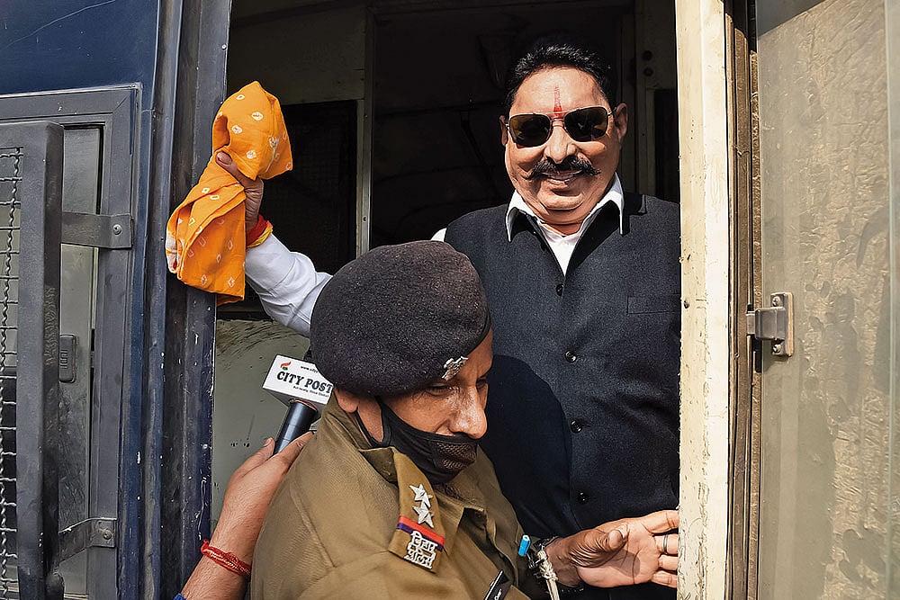 | Photo: Imago/Hindustan times : Land of the gangster-legislator: RJD MLA Anant Singh being detained by a police official on November 25, 2020, in Patna