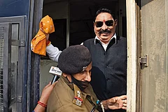 | Photo: Imago/Hindustan times : Land of the gangster-legislator: RJD MLA Anant Singh being detained by a police official on November 25, 2020, in Patna