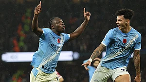 Jeremy Doku celebrates after scoring Manchester City's third goal
