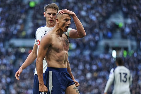 Tottenham's Richarlison celebrates with Tottenham's Radu Dragusin after scoring his side's second goal during the English Premier League soccer match between Tottenham Hotspur and Manchester United in London, England.