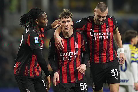 AC Milan's Alexis Saelemaekers, center, celebrates with Rafael Leao, left, and Strahinja Pavlovic after scoring his side's opening goal during the Serie A soccer match between Parma and Milan in Parma, Italy.