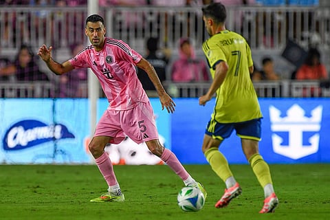 Inter Miami midfielder Sergio Busquets (5) defends Nashville SC midfielder Gastón Brugman (7) during the second half of Game 3 in the first round of MLS soccer's Western Conference playoffs in Fort Lauderdale, Florida.