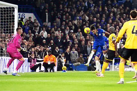Chelsea's Malo Gusto, center, scores his side's first goal during the English Premier League soccer against the Wolverhampton Wanderers in London.