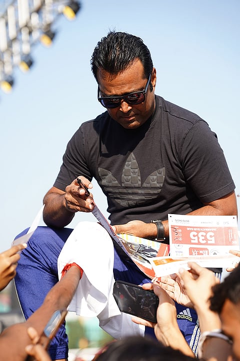 Former tennis player Leander Paes signs autographs during Kolkata Cyclothon 2025.