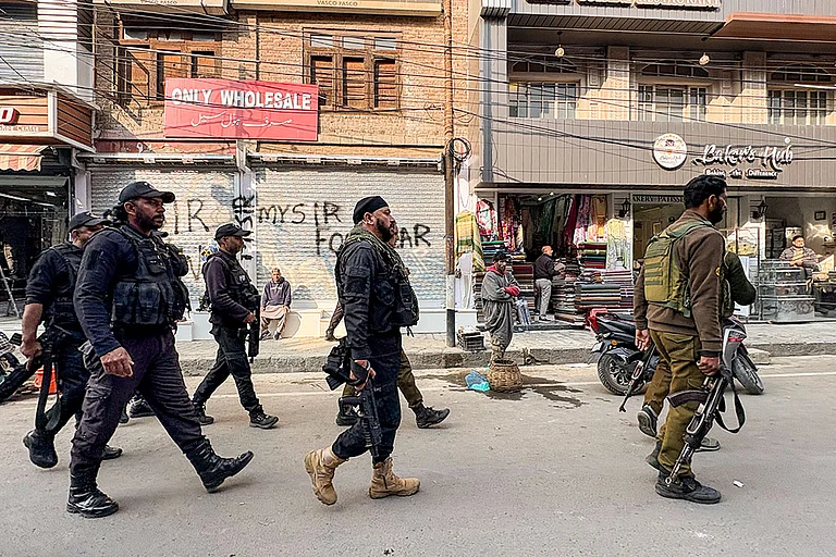 Security personnel stand guard following the arrest of Dr. Adeel (a resident of Wanpora, Kulgam), accused in an interstate and transnational terror module, in Anantnag. The arrest and subsequent terror module bust were results of a joint operation by the Faridabad and Jammu and Kashmir Police. - Photo: PTI