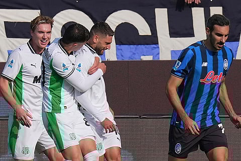 Sassuolo's Domenico Berardi, center, celebrates with teammates after scoring the opening goal during a Serie A soccer match between Atalanta and Sassuolo, in Bergamo, northern Italy.