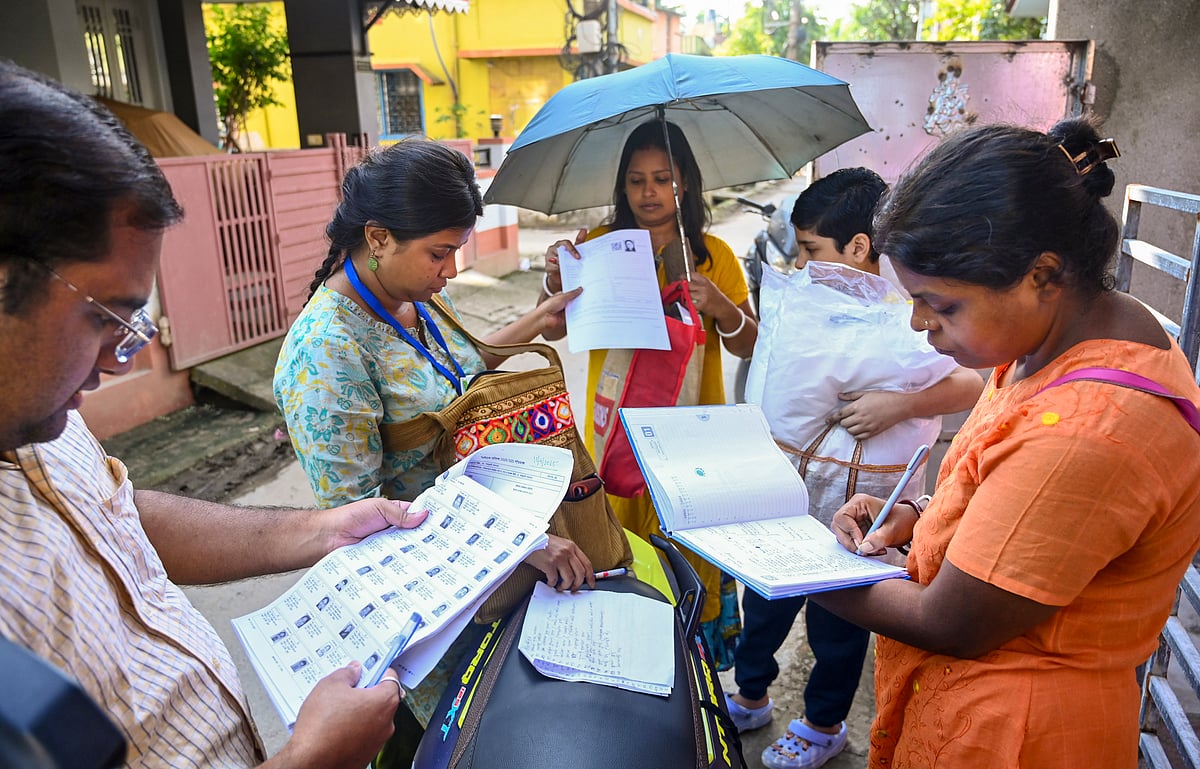 Booth Level Officers on field to distribute enumeration forms to voters as the Special Intensive Revision (SIR) of election rolls begins in West Bengal, at Balurghat in Dakshin Dinajpur district, Tuesday, Nov. 4, 2025. - PTI