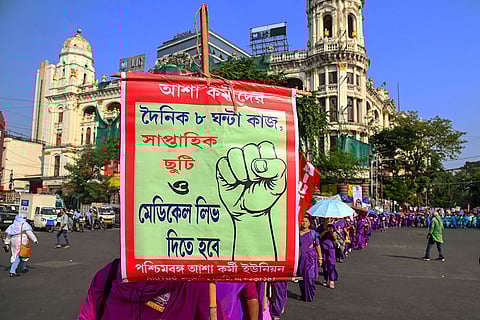 Members of the All India United Trade Union Centre (AIUTUC) participate in a protest rally against the Central and State Governments over various policies affecting labourers and workers, in Kolkata.