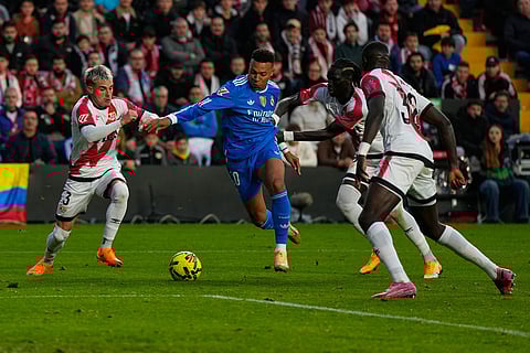 Rayo's Pep Chavarria, left, and teammates stop Real Madrid's Kylian Mbappe, center, from scoring during a Spanish La Liga soccer match between Rayo Vallecano and Real Madrid in Madrid, Spain.