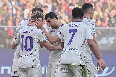 Fiorentina's Albert Gudmundsson, left, celebrates with teammates after scoring during a Serie A soccer match between Genoa and Fiorentina, in Genoa, Italy.