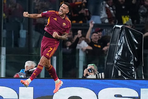 Roma's Lorenzo Pellegrini jumps in celebration after scoring his side's opening goal during the Serie A soccer match between Roma and Udinese, in Rome.