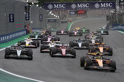 McLaren driver Lando Norris of Britain, right, leads the race after the start of the Brazilian Formula One Grand Prix at the Interlagos race track in Sao Paulo.