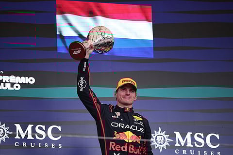 Red Bull driver Max Verstappen of the Netherlands celebrates on the podium his third place during the Brazilian Formula One Grand Prix at the Interlagos race track, in Sao Paulo.