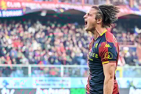 Genoa's Lorenzo Colombo celebrates after scoring his side's second goal during a Serie A soccer match between Genoa and Fiorentina, in Genoa, Italy.
