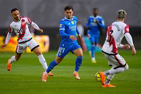 Real Madrid's Brahim Diaz, center, fights for the ball with Rayo's Alvaro Garcia, left, and Rayo's Pep Chavarria during Spanish La Liga soccer match between Rayo Vallecano and Real Madrid in Madrid, Spain.