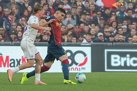 Genoa's Johan Vasquez, left, fights for the ball with Fiorentina's Albert Gudmundsson during a Serie A soccer match between Genoa and Fiorentina, in Genoa, Italy.