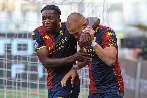 Genoa's Leo Skiri Ostigard, right, celebrates with teammate Brooke Norton-Cuffy after scoring the opening goal during a Serie A soccer match between Genoa and Fiorentina, in Genoa, Italy.
