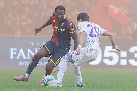 Genoa's Brooke Norton-Cuffy, left, fights for the ball with Fiorentina's Niccolò Fortini  during a Serie A soccer match between Genoa and Fiorentina, in Genoa, Italy.