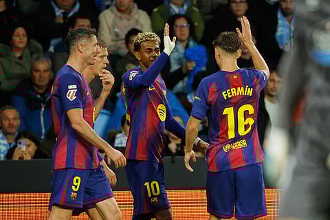 Barcelona's Lamine Yamal, center, is congratulated after scoring his side's 3rd goal during the Spanish La Liga soccer match between Celta Vigo and Barcelona in Vigo, Spain.