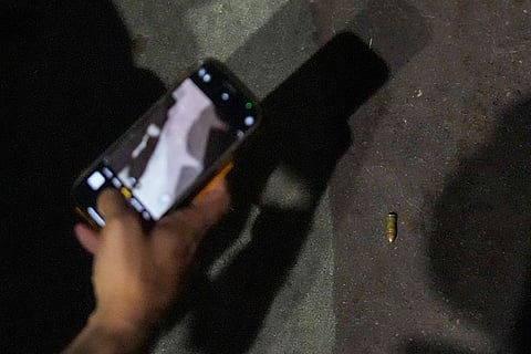 A bullet lies on the ground near the spot after a blast occurred in a parked car near Red Fort, leaving multiple vehicles in flames, in New Delhi.