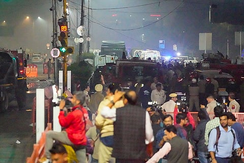 Emergency services personnel at the spot after a blast occurred in a parked car near Red Fort, leaving multiple vehicles in flames, in New Delhi.