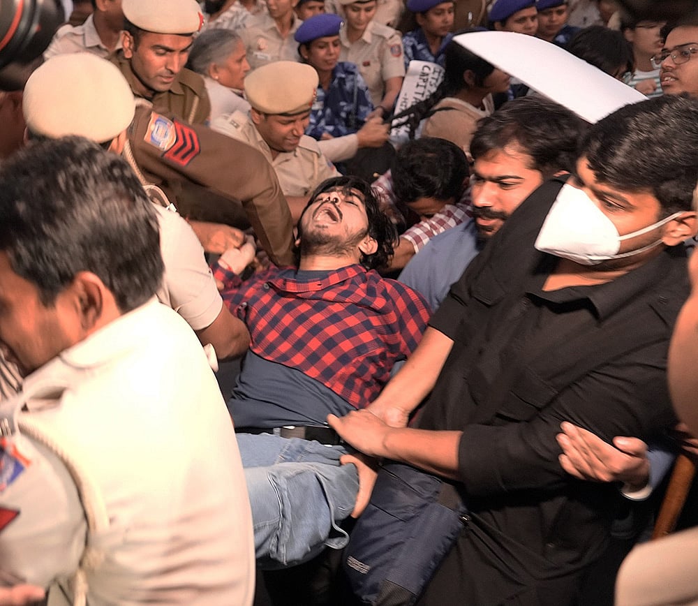 Police detain activists during the protest on Sunday