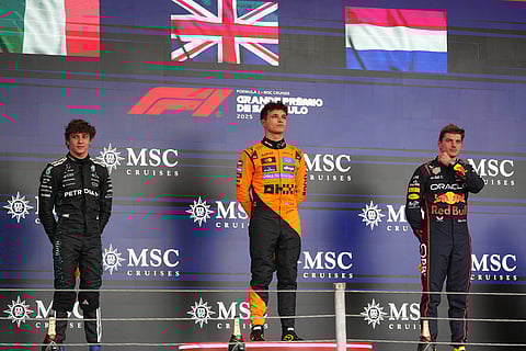 First place, McLaren driver Lando Norris of Britain, center, celebrates at the podium with second place, Mercedes driver Kimi Antonelli of Italy, left, and third place, Red Bull driver Max Verstappen of the Netherlands, during the Brazilian Formula One Grand Prix at the Interlagos race track, in Sao Paulo.