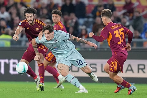 Udinese's Nicolo Zaniolo is challenged by Roma's Mario Hermoso, left, during the Serie A soccer match between Roma and Udinese, in Rome.