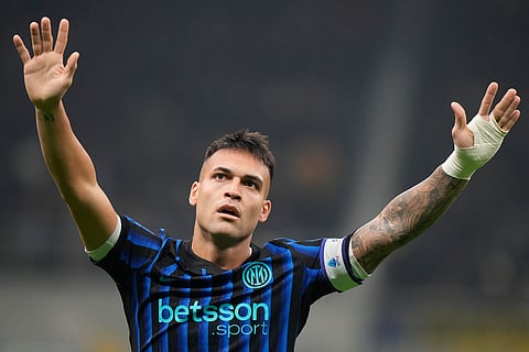 Inter Milan's Lautaro Martinez celebrates after scoring his side's opening goal during a Serie A soccer match between Inter Milan and Lazio, in Milan, Italy.