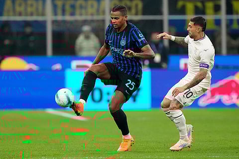 Inter Milan's Manuel Akanji is challenged by Lazio's Mattia Zaccagni, right, during a Serie A soccer match between Inter Milan and Lazio, in Milan, Italy.
