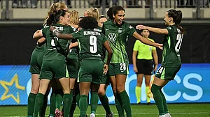 Swen Pfortner/dpa via AP : VfL Wolfsburg players celebrate after Paris St. Germain's Jackie Groenen scored an own goal during a Women's Champions League match in Wolfsburg, Germany.