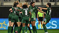 Swen Pfortner/dpa via AP : VfL Wolfsburg players celebrate after Paris St. Germain's Jackie Groenen scored an own goal during a Women's Champions League match in Wolfsburg, Germany.
