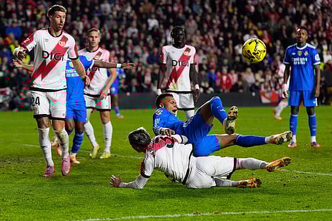 Real Madrid's Kylian Mbappe collides with Rayo's Pep Chavarria in an attempt to score during a Spanish La Liga soccer match between Rayo Vallecano and Real Madrid in Madrid, Spain.