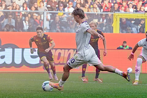 Fiorentina's Albert Gudmundsson shoots and scores on a penalty kick during a Serie A soccer match between Genoa and Fiorentina, in Genoa, Italy.